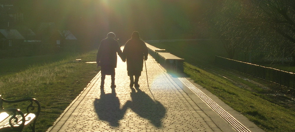 An old couple, walking together.